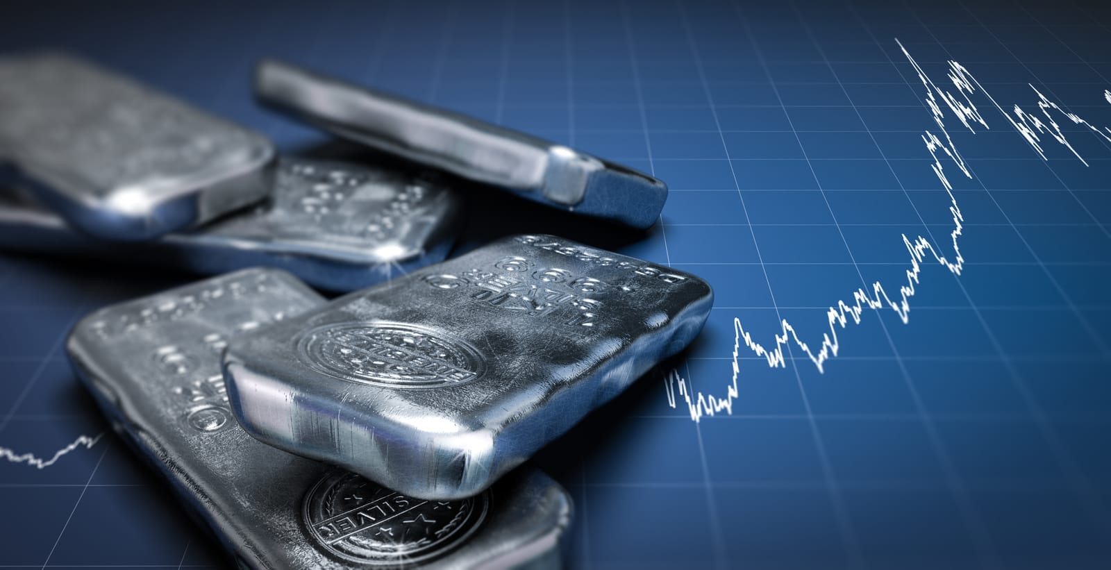 Image of several silver bars stacked on a blue grid surface. In the background, a white line graph is visible, suggesting financial trends or stock market fluctuations. The silver bars are shiny and detailed in close-up.